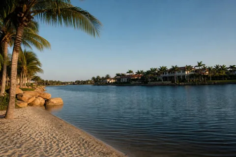 Lakefront homes and lake beach at Miromar Lakes, Florida